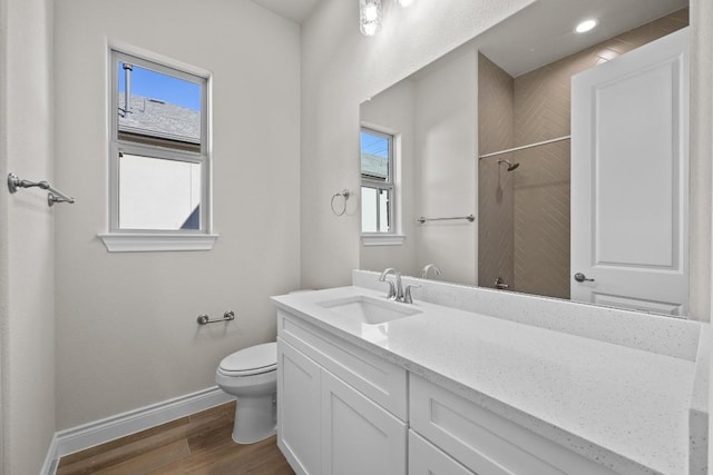 bathroom featuring vanity, hardwood / wood-style flooring, toilet, and a wealth of natural light