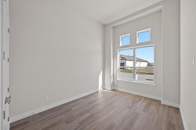 empty room with light hardwood / wood-style flooring