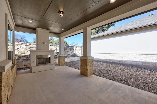 view of patio with exterior fireplace