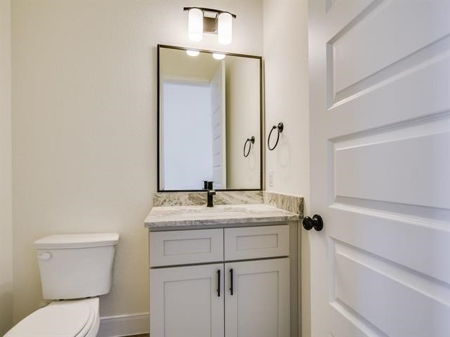 bathroom featuring vanity and toilet