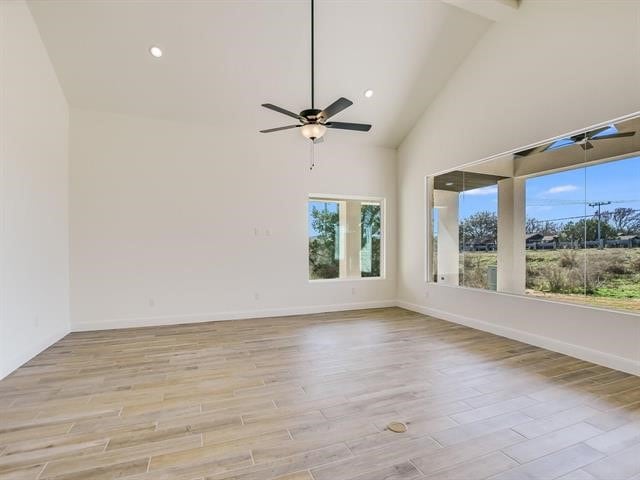 unfurnished room with beam ceiling, ceiling fan, and high vaulted ceiling