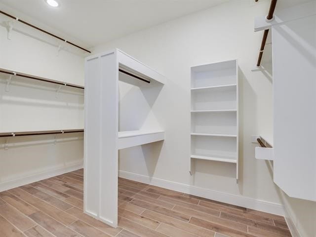 spacious closet with light hardwood / wood-style flooring