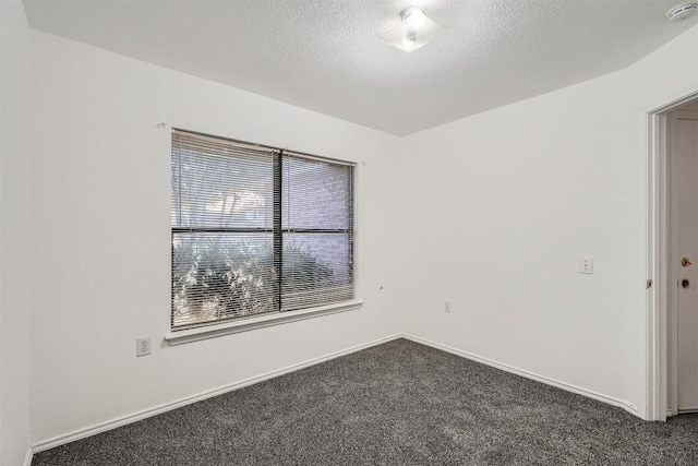 carpeted empty room with a textured ceiling