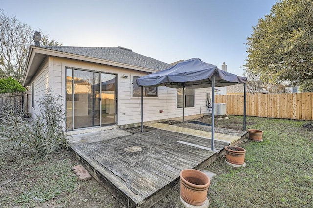 deck featuring a lawn and central AC unit