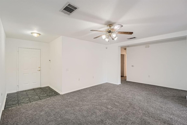 carpeted spare room featuring ceiling fan