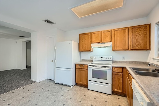 kitchen with sink, light colored carpet, and white appliances