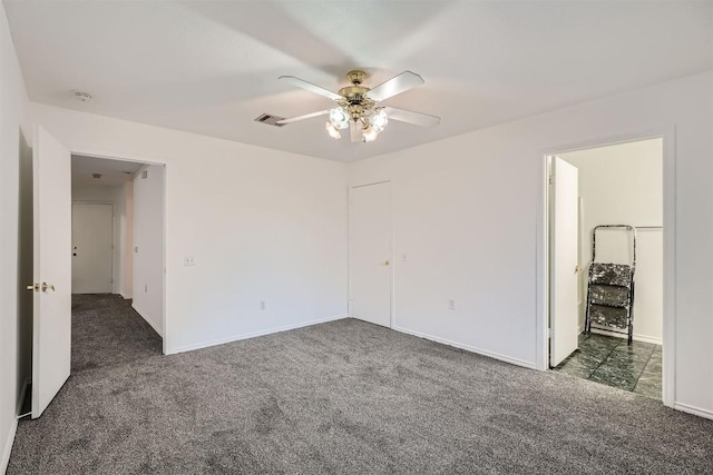 unfurnished bedroom with dark colored carpet and ceiling fan