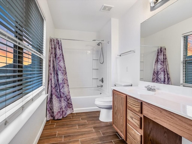 full bathroom with vanity, shower / bath combination with curtain, and toilet