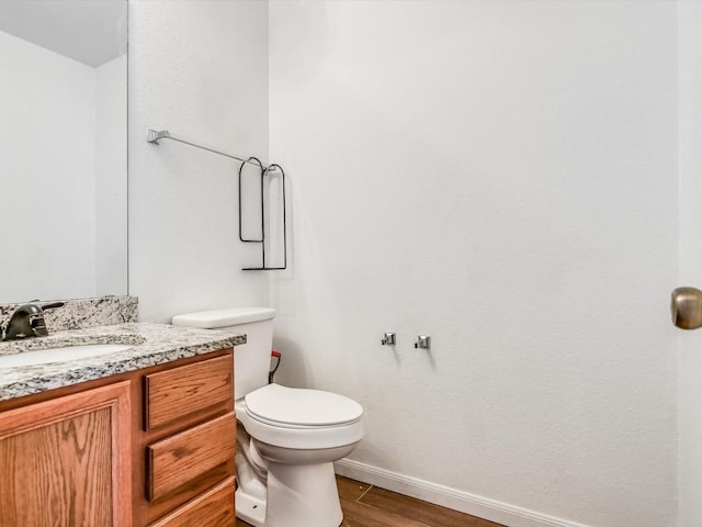 bathroom featuring vanity, toilet, and wood-type flooring