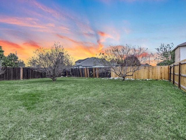 view of yard at dusk