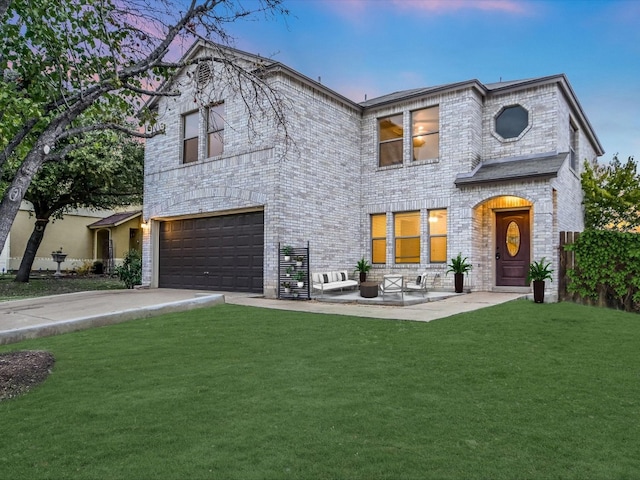 view of front of home with a yard and a garage