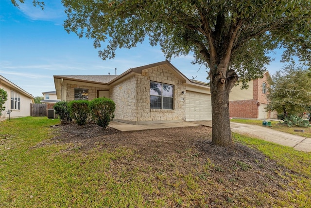 view of front of house with central AC, a front yard, and a garage