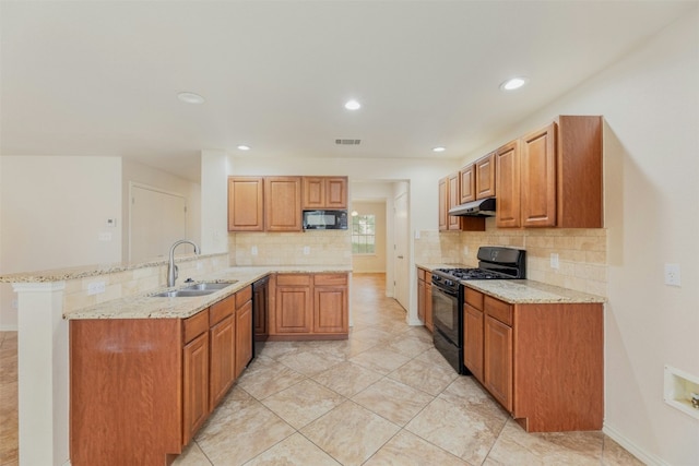 kitchen featuring black appliances, sink, decorative backsplash, light stone counters, and kitchen peninsula