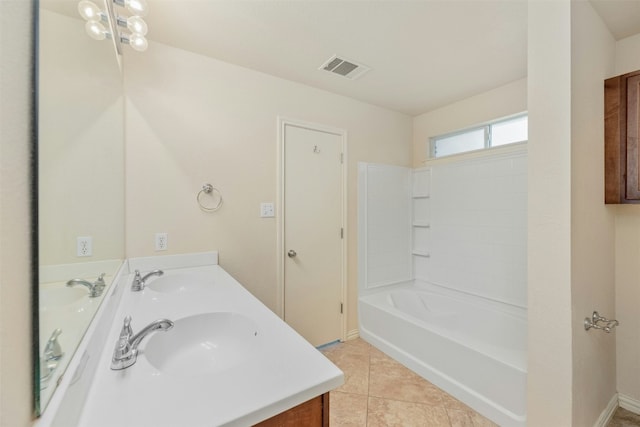 bathroom with tile patterned flooring, vanity, and  shower combination