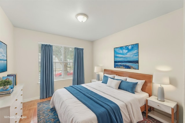 bedroom featuring light parquet flooring