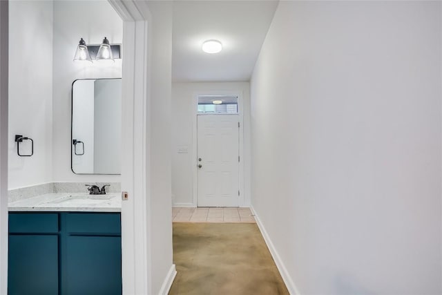 interior space with light tile patterned floors and sink