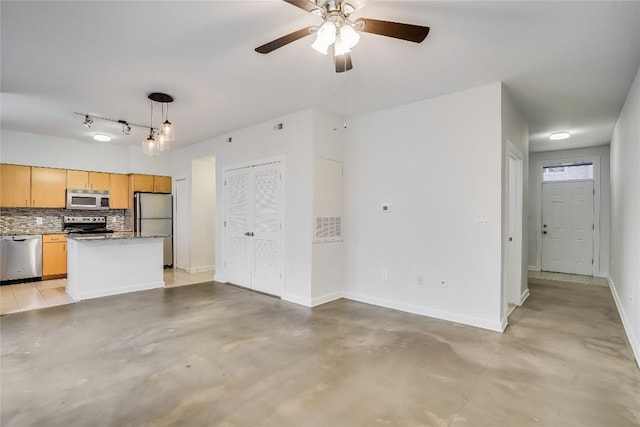 kitchen featuring ceiling fan, hanging light fixtures, stainless steel appliances, decorative backsplash, and light brown cabinetry