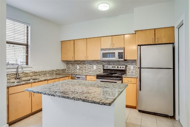 kitchen featuring backsplash, sink, a kitchen island, and appliances with stainless steel finishes