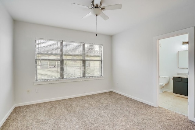 unfurnished room with ceiling fan and light carpet