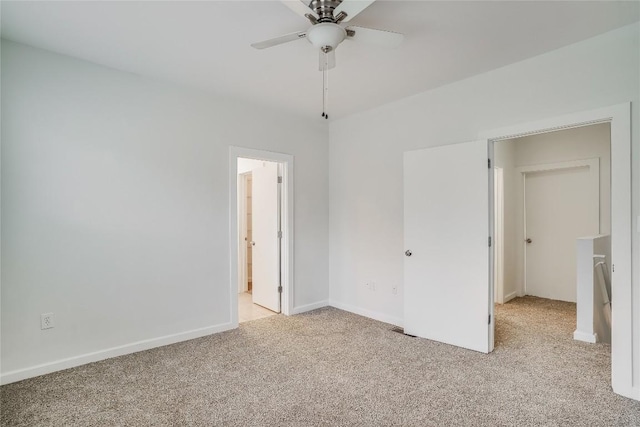 unfurnished bedroom with ensuite bath, ceiling fan, and light carpet