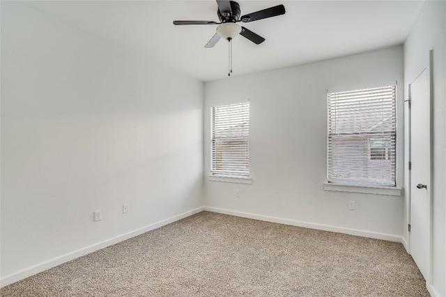 spare room featuring carpet floors, plenty of natural light, and ceiling fan