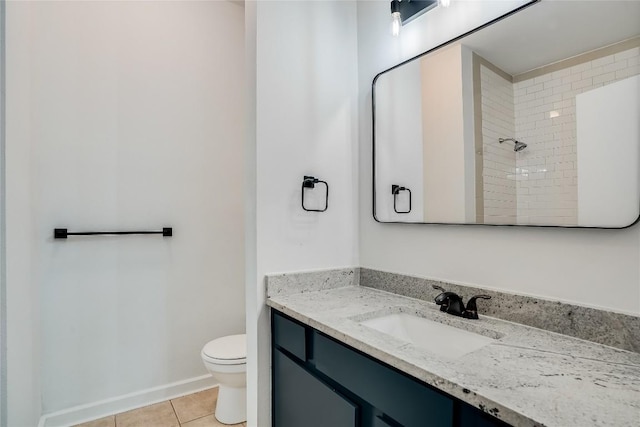 bathroom with tile patterned floors, vanity, toilet, and walk in shower