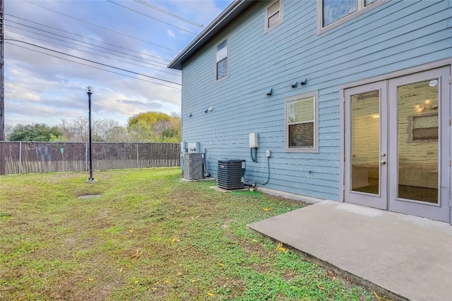 view of yard with central AC unit and a patio area