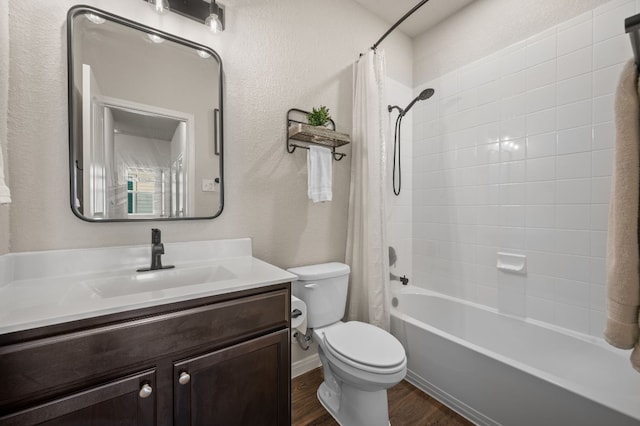 full bathroom featuring vanity, toilet, wood-type flooring, and shower / tub combo