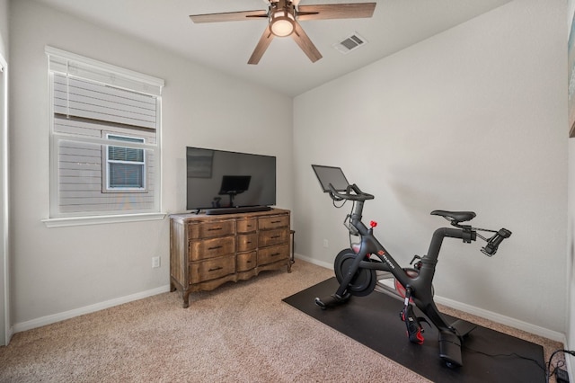 workout room with light carpet and ceiling fan