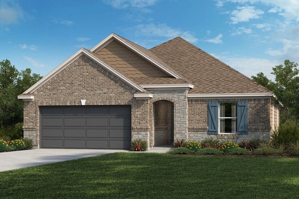 view of front facade with a front yard and a garage