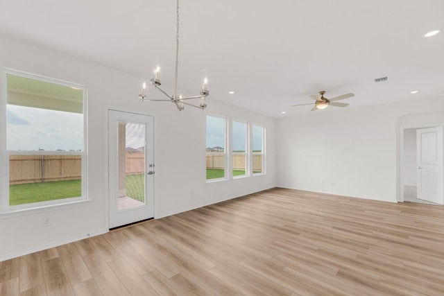 unfurnished living room with recessed lighting, visible vents, light wood finished floors, and ceiling fan with notable chandelier