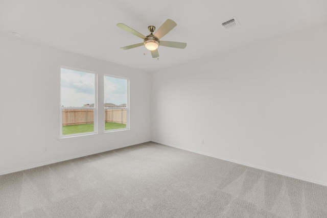 spare room with baseboards, visible vents, and carpet