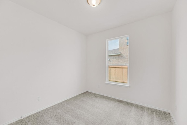 spare room with carpet flooring and baseboards