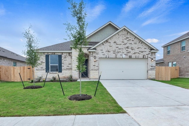 view of front of property featuring fence, an attached garage, driveway, and a front lawn