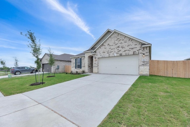 view of front facade with a front lawn, fence, brick siding, an attached garage, and driveway