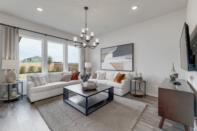 living room with a notable chandelier and hardwood / wood-style flooring