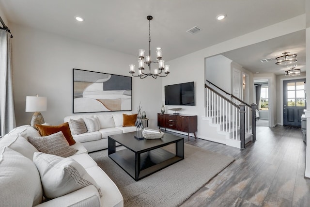 living room with dark hardwood / wood-style flooring and a chandelier