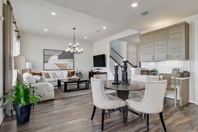 dining area featuring hardwood / wood-style floors and a chandelier