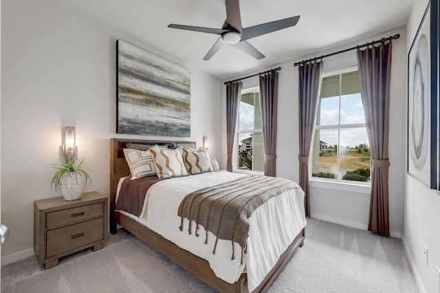 carpeted bedroom with multiple windows and ceiling fan