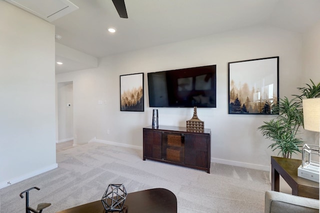 carpeted living room featuring ceiling fan and vaulted ceiling