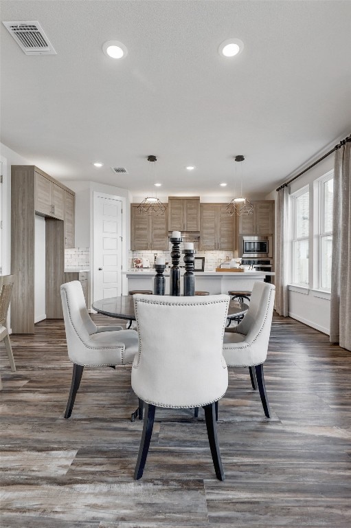 dining space with dark hardwood / wood-style floors