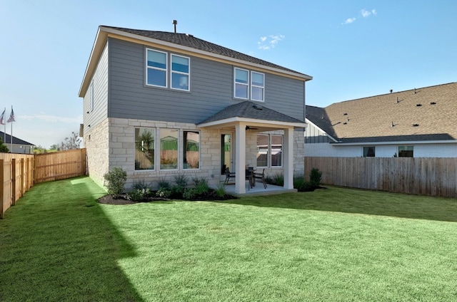 back of property with a lawn and a patio