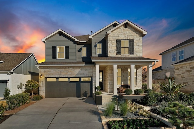 view of front of property with covered porch and a garage