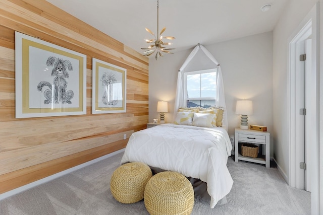 bedroom featuring light carpet, wooden walls, and an inviting chandelier