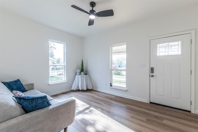 living area featuring hardwood / wood-style floors and ceiling fan