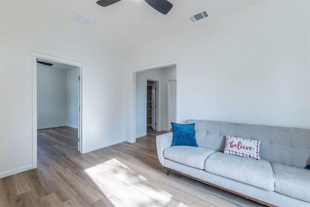 living room featuring ceiling fan and light hardwood / wood-style floors