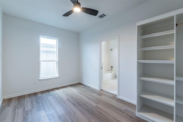 spare room featuring light hardwood / wood-style flooring and ceiling fan