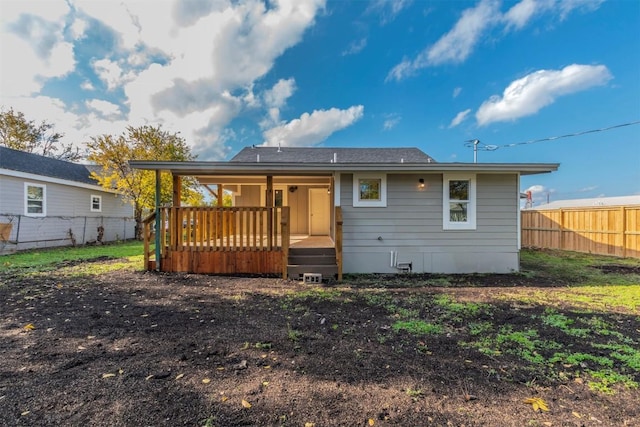 back of house featuring a wooden deck