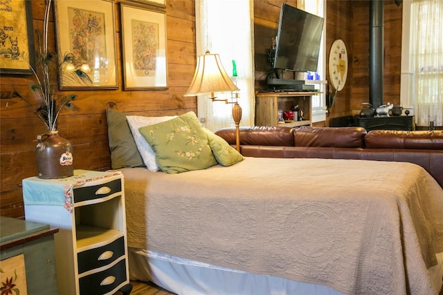 bedroom featuring wooden walls