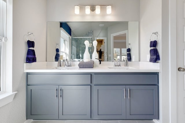 bathroom featuring vanity and an enclosed shower